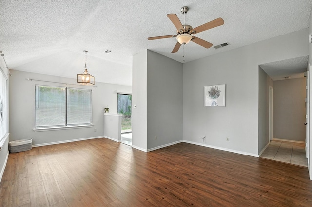 1450 Hampton Rd, Grapevine, TX 76051 - unfurnished living room featuring wood finished floors, a textured ceiling, ceiling fan, vaulted ceiling, and a chandelier