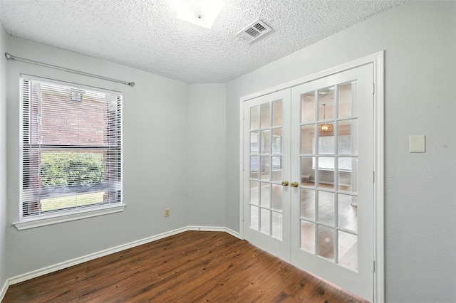 1450 Hampton Rd, Grapevine, TX 76051 - spare room with french doors, dark wood-style flooring, and a textured ceiling