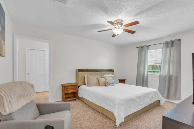 2212 Hurstview Dr, Hurst, TX 76054 - bedroom featuring ceiling fan, light colored carpet, and a textured ceiling