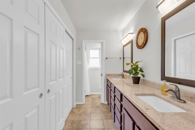 2212 Hurstview Dr, Hurst, TX 76054 - full bath with double vanity, tile patterned flooring, and a closet