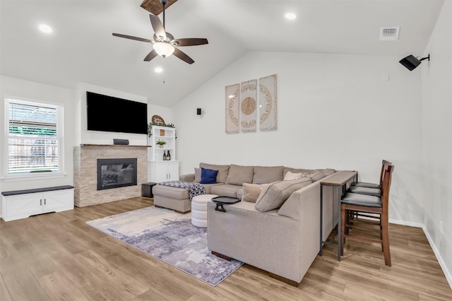 2212 Hurstview Dr, Hurst, TX 76054 - living area featuring a ceiling fan, vaulted ceiling, light wood-style floors, a glass covered fireplace, and recessed lighting