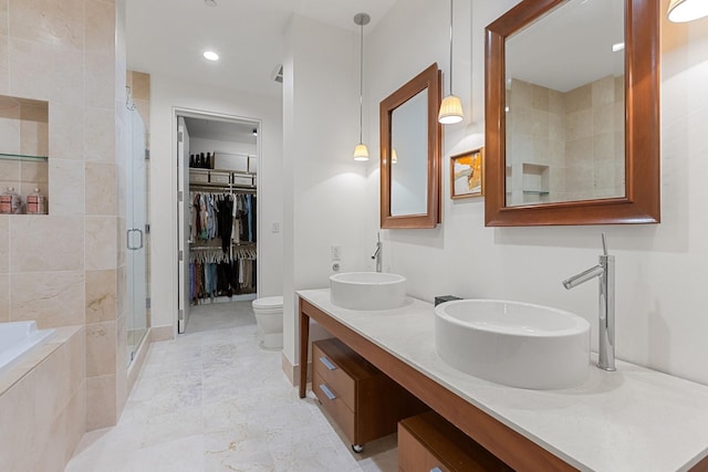 2200 Victory Ave Unit 1105, Dallas, TX 75219 - bathroom featuring a shower stall, double vanity, a bath, and a walk in closet