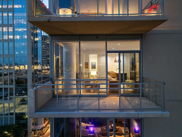 2200 Victory Ave Unit 1105, Dallas, TX 75219 - back of house at night featuring a balcony