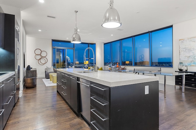 2200 Victory Ave Unit 1105, Dallas, TX 75219 - kitchen with modern cabinets, light countertops, dark wood-type flooring, a center island with sink, and pendant lighting