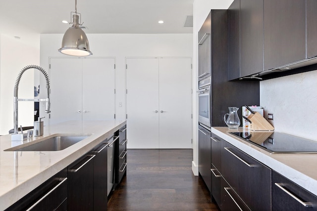 2200 Victory Ave Unit 1105, Dallas, TX 75219 - kitchen with black electric stovetop, dark wood-style floors, oven, decorative light fixtures, and recessed lighting