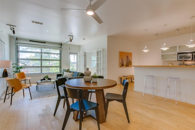 1111 S Akard St Unit 310, Dallas, TX 75215 - dining room featuring light wood-type flooring, track lighting, and ceiling fan