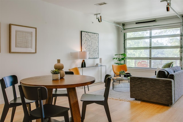 1111 S Akard St Unit 310, Dallas, TX 75215 - dining space with light wood-style flooring