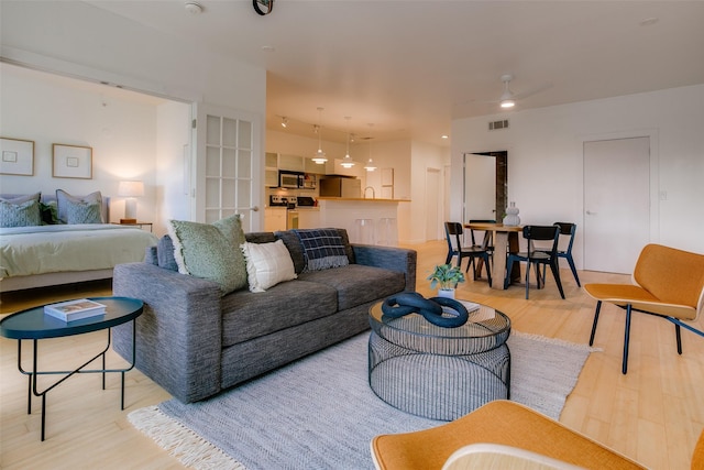 1111 S Akard St Unit 310, Dallas, TX 75215 - living room with light wood-style flooring and ceiling fan