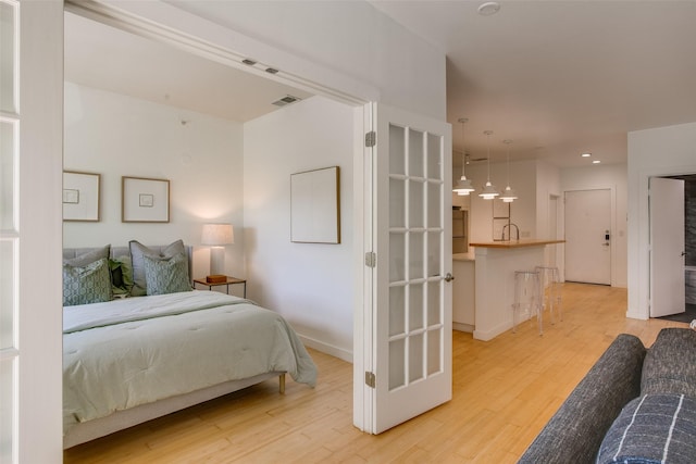 1111 S Akard St Unit 310, Dallas, TX 75215 - bedroom featuring light wood finished floors and recessed lighting