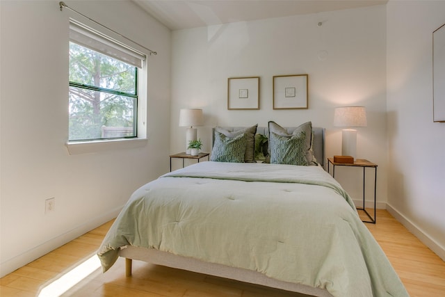 1111 S Akard St Unit 310, Dallas, TX 75215 - bedroom with wood finished floors and baseboards
