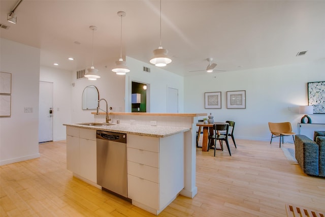 1111 S Akard St Unit 310, Dallas, TX 75215 - kitchen featuring stainless steel dishwasher, modern cabinets, a kitchen island with sink, light wood-type flooring, and decorative light fixtures