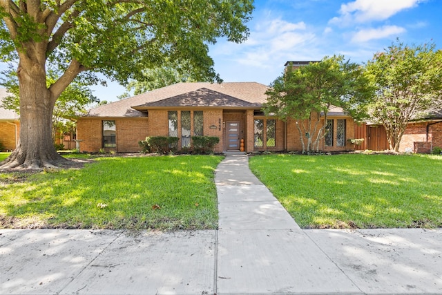 3948 Camino Dr, Plano, TX 75074 - view of front of home featuring brick siding, a front lawn, and roof with shingles