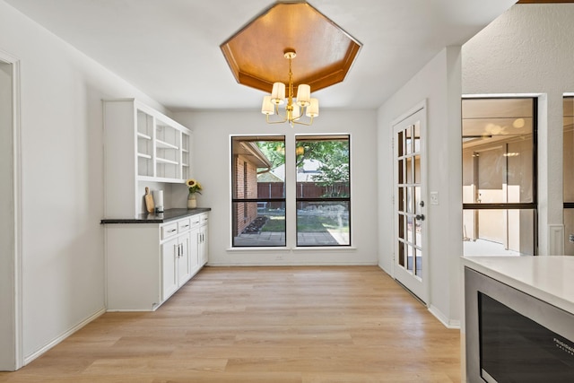 3948 Camino Dr, Plano, TX 75074 - unfurnished dining area with a chandelier and light wood finished floors