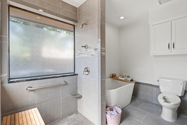 3948 Camino Dr, Plano, TX 75074 - bathroom featuring tile patterned flooring, a freestanding bath, a tile shower, and tile walls