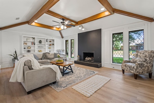 3948 Camino Dr, Plano, TX 75074 - living area featuring ceiling fan, light wood-type flooring, and a fireplace
