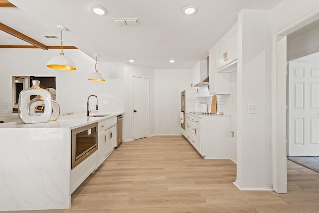 3948 Camino Dr, Plano, TX 75074 - kitchen featuring appliances with stainless steel finishes, white cabinetry, decorative backsplash, light wood-style floors, and recessed lighting