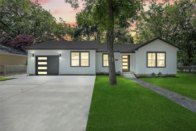 812 Sylvan Dr, Garland, TX 75040 - view of front of house featuring driveway, an attached garage, board and batten siding, and a shingled roof