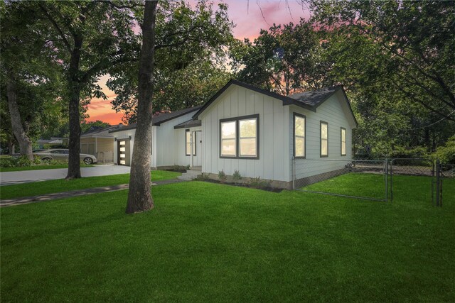 812 Sylvan Dr, Garland, TX 75040 - view of front facade with board and batten siding, a garage, and driveway