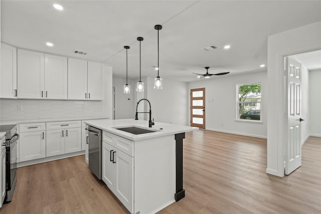 812 Sylvan Dr, Garland, TX 75040 - kitchen featuring stainless steel appliances, recessed lighting, decorative backsplash, light wood finished floors, and light countertops