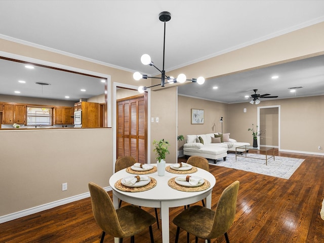 4108 Grand Lake Dr, Lake Worth, TX 76135 - dining area featuring ornamental molding, dark wood finished floors, a ceiling fan, recessed lighting, and a chandelier