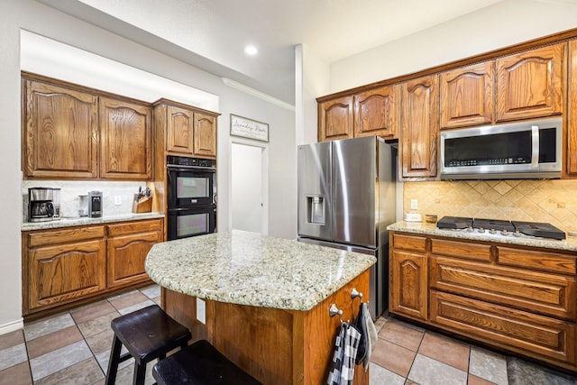 8700 Blacktail Trl, Mckinney, TX 75070 - kitchen with appliances with stainless steel finishes, decorative backsplash, a kitchen bar, light stone counters, and ornamental molding