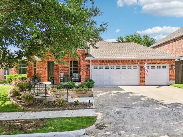 8700 Blacktail Trl, Mckinney, TX 75070 - view of front of house featuring a garage, concrete driveway, a shingled roof, and brick siding