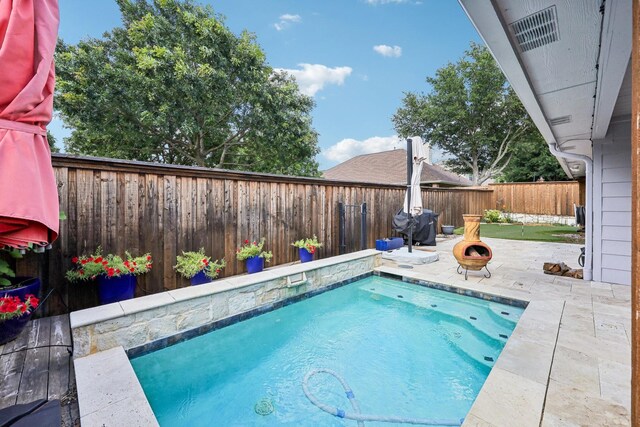 8700 Blacktail Trl, Mckinney, TX 75070 - view of swimming pool featuring a patio, a fenced backyard, and a fire pit