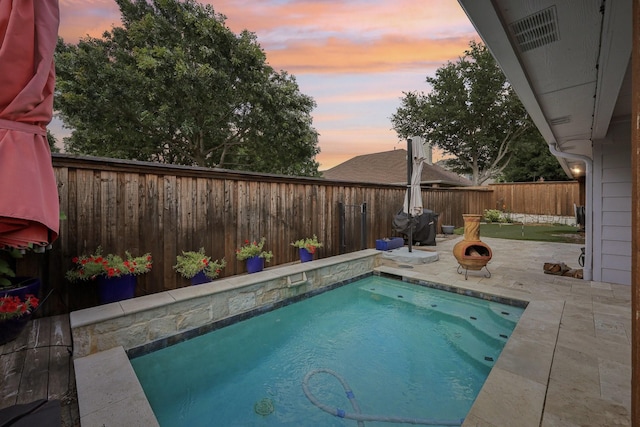 8700 Blacktail Trl, Mckinney, TX 75070 - pool at dusk featuring a patio and a fenced backyard