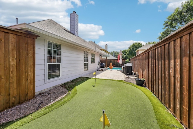 8700 Blacktail Trl, Mckinney, TX 75070 - fenced backyard with a putting green and a patio area
