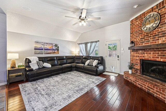 8700 Blacktail Trl, Mckinney, TX 75070 - living area with ceiling fan, a brick fireplace, dark wood finished floors, and vaulted ceiling