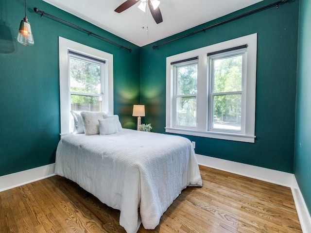 2719 W 12th St, Dallas, TX 75211 - bedroom with multiple windows, wood finished floors, and ceiling fan