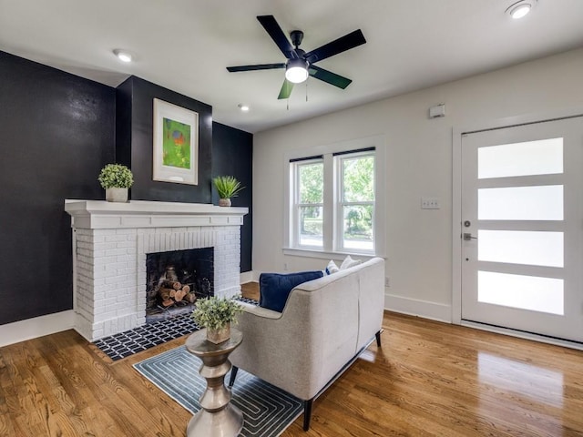 2719 W 12th St, Dallas, TX 75211 - living room with wood finished floors, a brick fireplace, a ceiling fan, and recessed lighting