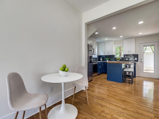 2719 W 12th St, Dallas, TX 75211 - dining space featuring light wood-type flooring and recessed lighting