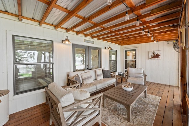 111 Adams Row, Streetman, TX 75859 - living room featuring hardwood / wood-style floors, french doors, plenty of natural light, and wooden walls
