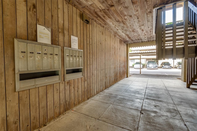 4505 N O Connor Rd Unit 1125, Irving, TX 75062 - corridor with wood walls, wooden ceiling, and mail area