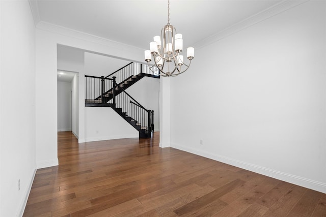 1014 Ember Crest Dr, Rockwall, TX 75087 - spare room with stairs, wood finished floors, crown molding, and a chandelier