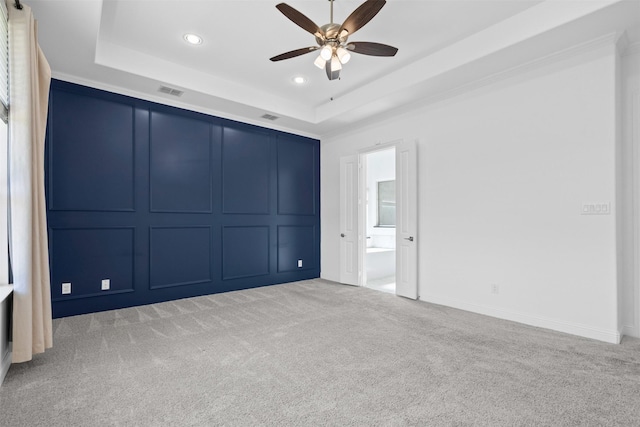1014 Ember Crest Dr, Rockwall, TX 75087 - unfurnished bedroom featuring a raised ceiling, recessed lighting, light carpet, and ensuite bathroom