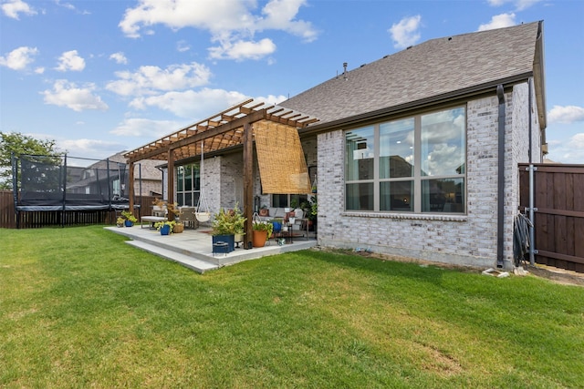 1014 Ember Crest Dr, Rockwall, TX 75087 - rear view of property with a trampoline, brick siding, a patio, a pergola, and a shingled roof