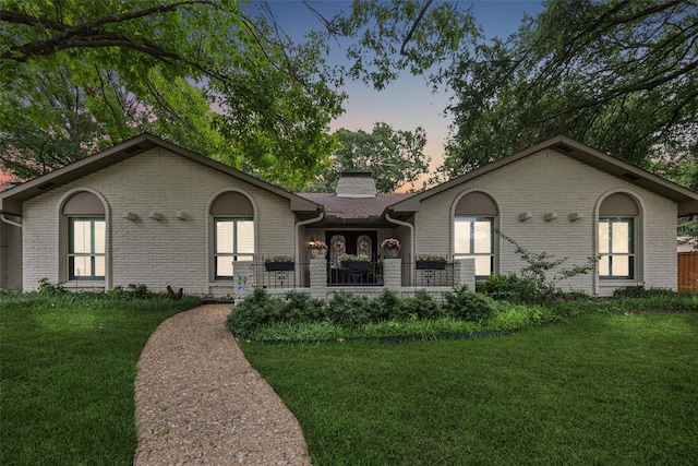 12312 Cox Ln, Dallas, TX 75244 - ranch-style home featuring brick siding, a front yard, and a chimney