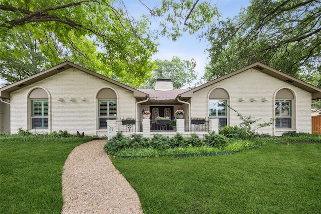 12312 Cox Ln, Dallas, TX 75244 - single story home with brick siding, a front lawn, and a chimney