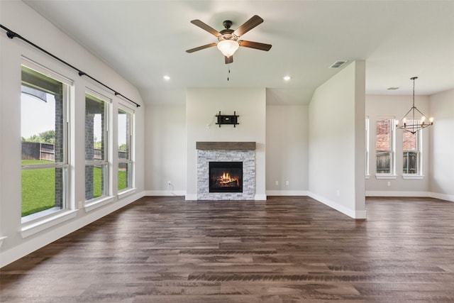 7709 Potter St, Rowlett, TX 75089 - unfurnished living room featuring dark wood-type flooring, a chandelier, a stone fireplace, a ceiling fan, and recessed lighting