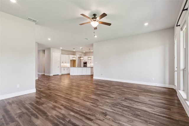 7709 Potter St, Rowlett, TX 75089 - unfurnished living room featuring a ceiling fan, dark wood-type flooring, and recessed lighting
