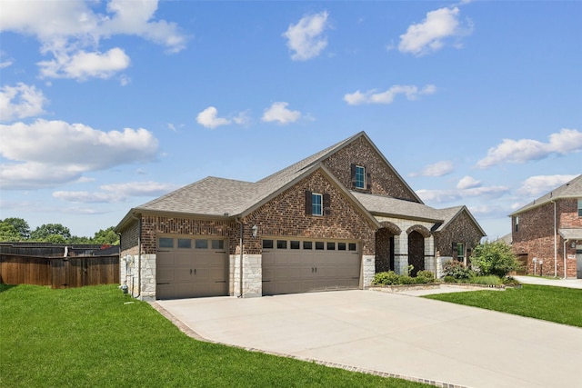 7709 Potter St, Rowlett, TX 75089 - french country style house with a garage, concrete driveway, roof with shingles, and stone siding