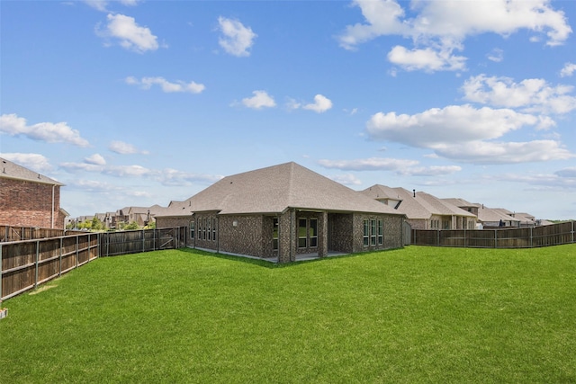 7709 Potter St, Rowlett, TX 75089 - rear view of property featuring a fenced backyard, brick siding, and roof with shingles