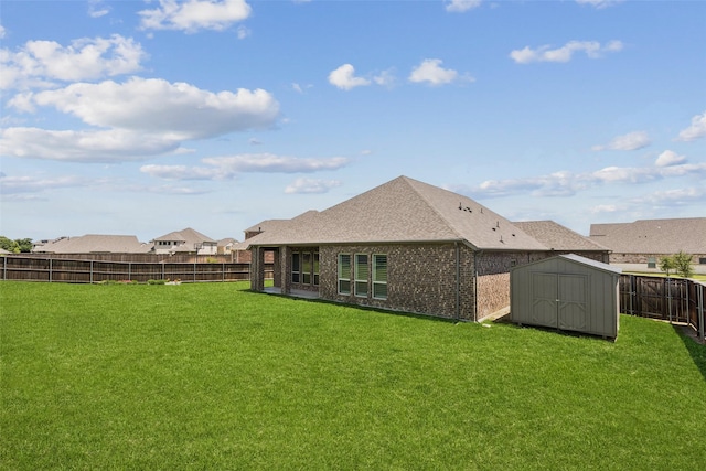 7709 Potter St, Rowlett, TX 75089 - back of house with a fenced backyard, a shed, brick siding, and a shingled roof