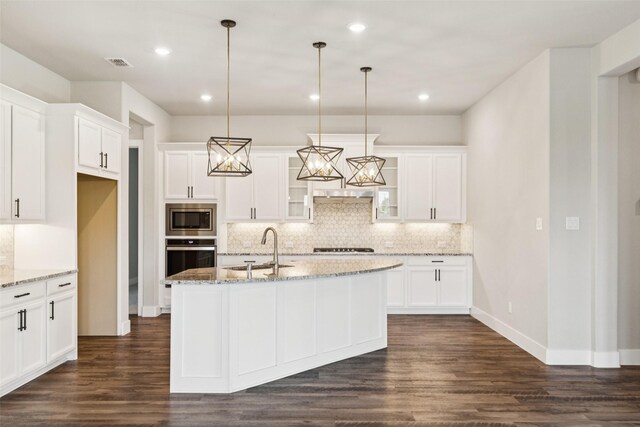 7709 Potter St, Rowlett, TX 75089 - kitchen featuring stainless steel appliances, decorative backsplash, dark wood finished floors, white cabinets, and recessed lighting
