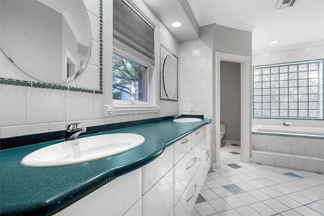 308 Westlane Cir, Woodway, TX 76712 - full bathroom featuring crown molding, tiled tub, tile patterned flooring, double vanity, and recessed lighting