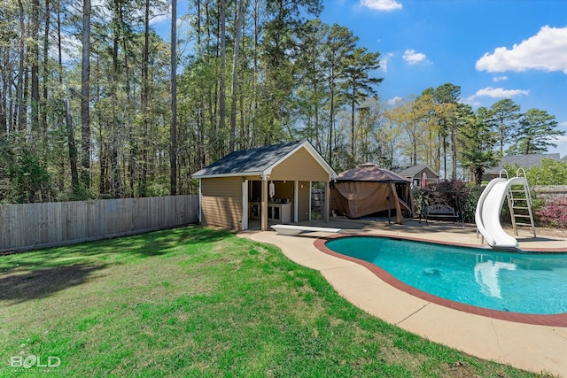 2018 Honeytree Trl, Haughton, LA 71037 - view of swimming pool featuring a water slide, a fenced backyard, an outbuilding, a diving board, and a patio area