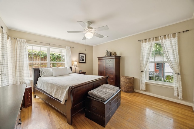1147 N Windomere Ave, Dallas, TX 75208 - bedroom with light wood-style floors, multiple windows, ornamental molding, and ceiling fan