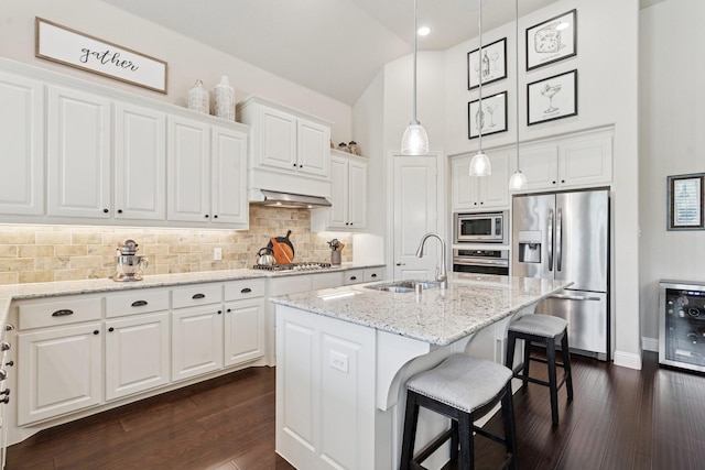 14845 Belclaire Ave, Aledo, TX 76008 - kitchen with stainless steel appliances, wine cooler, white cabinetry, decorative backsplash, and high vaulted ceiling